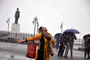 A girl enjoys first snowfall of the season on Christmas in Shimla