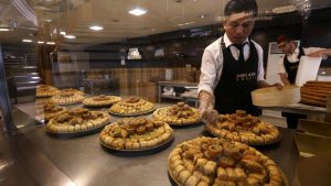 A man prepares to pack traditional sweets, in Arbil, the capital of the Kurdish autonomous region in northern Iraq.