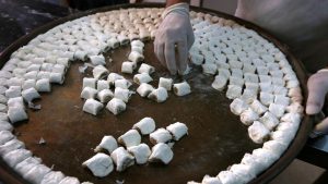 A man prepares traditional sweets, in Arbil, the capital of the Kurdish autonomous region in northern Iraq.