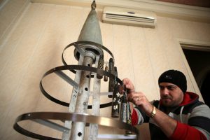 Akram Abu al-Foz decorates a Christmas tree with empty shells, which he collected and painted, in the rebel held besieged city of Douma, in the eastern Damascus suburb of Ghouta, Syria December 23, 2016. Picture taken December 23, 2016.