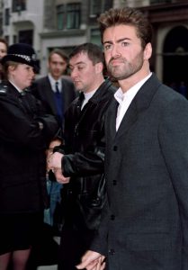 This file photo taken on October 28, 1993, in London, shows British pop superstar George Michael leaving the high court after his first day on the witness stand during his attempt to break from his record company Sony.