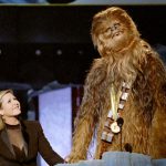 Chewbacca, the eight-foot tall, 200 year-old ‘wookie’ character from ‘Star Wars’, gives his acceptance speech in his own tongue upon receiving the MTV Movie Awards Lifetime Achievement from Carrie Fisher (L), who played Princess Leia Organa in the same movie, on June 7, 1997.