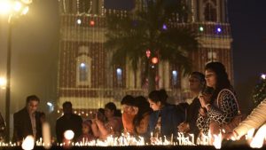 Devotees lights the candles at the Sacred Heart Cathedral on Christmas Eve in New Delhi