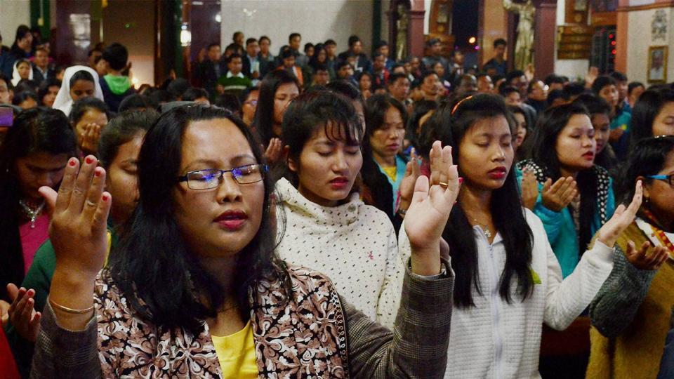 Devotees offer prayers at a church on the occasion of Christmas in Agartala, Tripura
