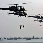 Indian Navy marine commandos demonstrate their skills during the Navy Day celebrations in Mumbai