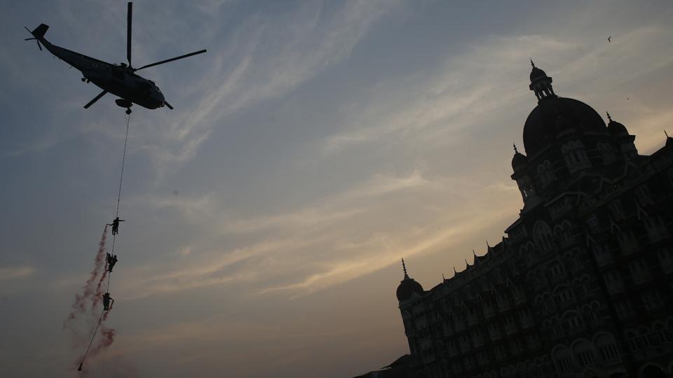 Indian navy personnel display their skills next to the Taj Mahal Palace Hotel during Naval Day celebrations