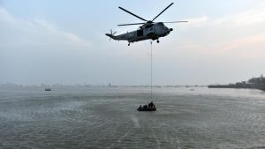 Marine commandos demonstrate rescue operation during Navy Day celebration at Gateway of India in Mumbai