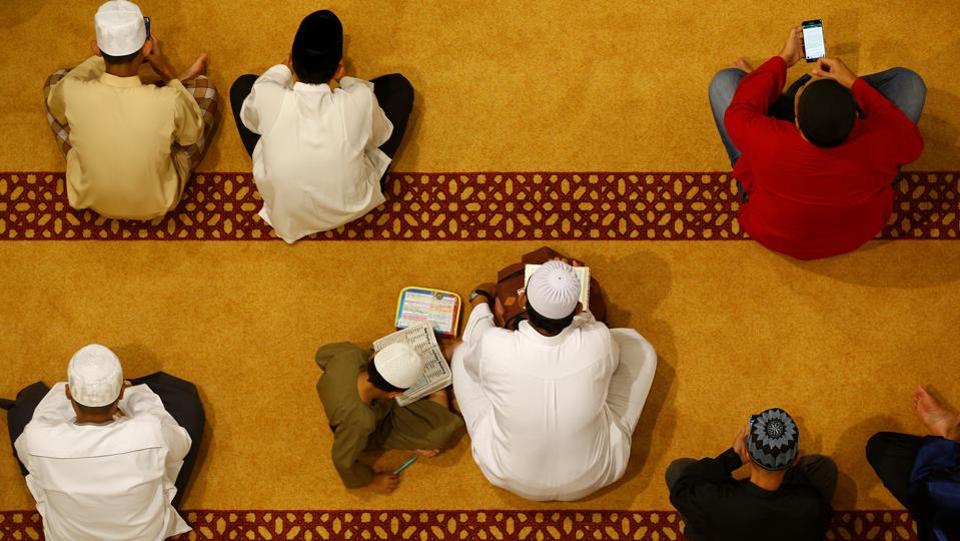 Muslims wait to perform ‘Tarawih’ prayers to mark the start of Ramadan at a mosque in Singapore.