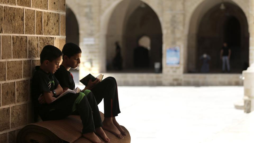 Palestinian children read copies of the Koran, at the al-Omari mosque in Gaza City.