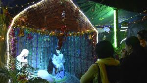People gather infront of a Nativity scene in Ghaziabad