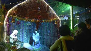 People gather infront of a Nativity scene in Ghaziabad