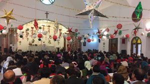 People pray on Christmas Day at Epiphany Church in Gurgaon
