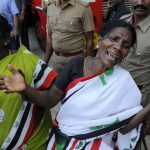 Supporters of former Tamil Nadu chief Minister J. Jayalalithaa react as they wait to catch a glimpse of her funeral procession in Chennai on December 6, 2016.