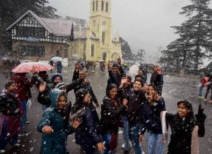 Tourists enjoy first snowfall of the season on the Christmas eve, in Shimla