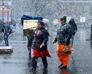 Tourists enjoy first snowfall of the season on the Christmas eve, in Shimla