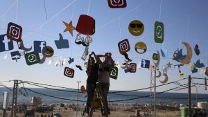 Workers decorate the seaside yard of a coffee at the main beach road, in Gaza City.