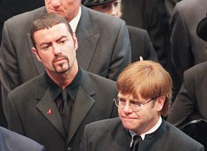 This file photo taken on September 6, 1997 shows pop stars George Michael (L) and Elton John (R) leaving Westminster Abbey following the funeral service of Diana, Princess of Wales.