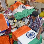A man works on the Indian National Flag at Mahalaxmi. The ratio of the width to the length of the flag is 2:3