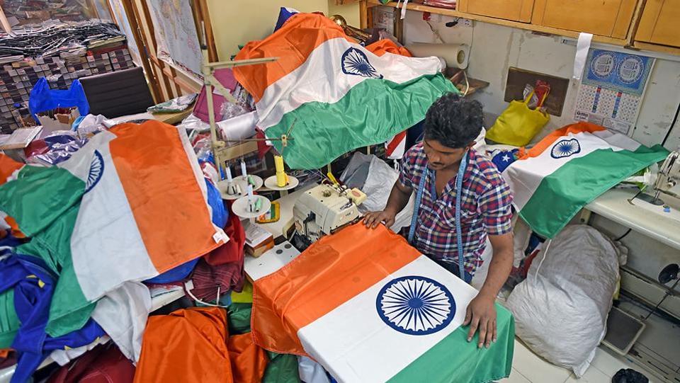 A man works on the Indian National Flag at Mahalaxmi. The ratio of the width to the length of the flag is 2:3