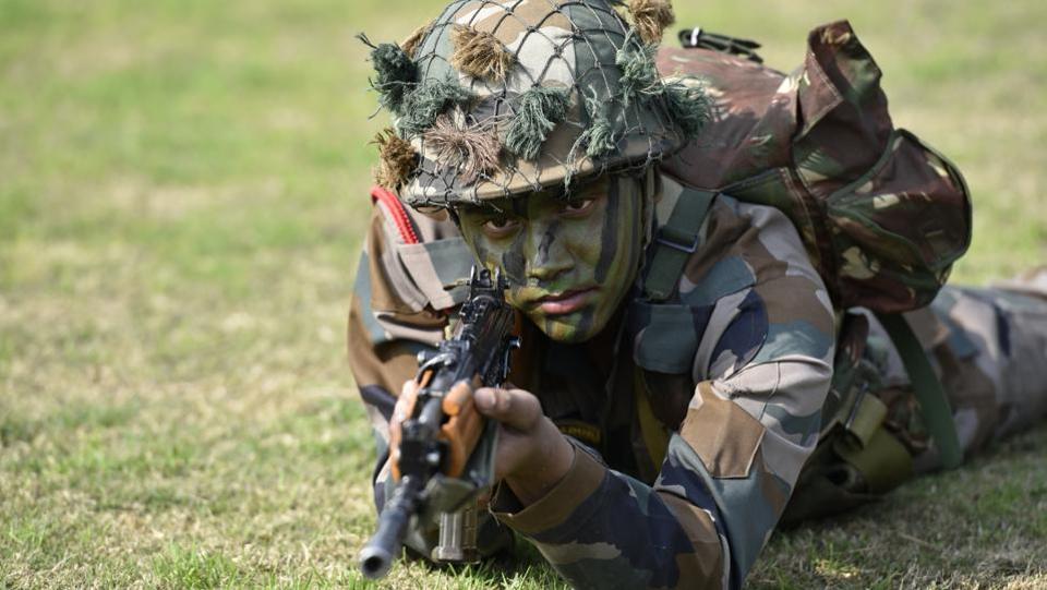 Army soldiers display their war skills during the Army Day parade at Delhi Cantt in New Delhi