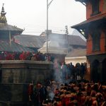 Devotees return after taking a holy bath at Bagmati river in Pashupatinath Temple during the Swasthani Brata Katha festival in Kathmandu, Nepal