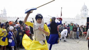 Devotees showcase martial performances during the Nagar Kirtan in Patiala