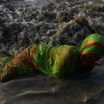Devotees take holy bath and perform rituals in the Bay of Bengal at the mouth of the river Ganges in Sagar Island