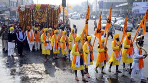 Devotees taking part in Nagar Kirtan on the 350th birth anniversary celebrations of Guru Gobind Singh in Patiala