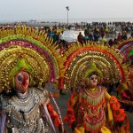 Folk dancers perform the ‘Chhou’ dance for Hindu devotees taking a holy bath and performing rituals at the Gangasagar Island