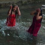 Nepalese Hindu devotees gather to bathe in the Shali river on the outskirts of Kathmandu