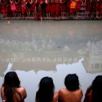 Pashupatinath Temple is reflected on the Bagmati River as devotees offer prayers during the Swasthani Brata Katha festival in Kathmandu, Nepal
