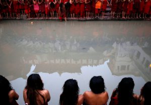 Pashupatinath Temple is reflected on the Bagmati River as devotees offer prayers during the Swasthani Brata Katha festival in Kathmandu, Nepal