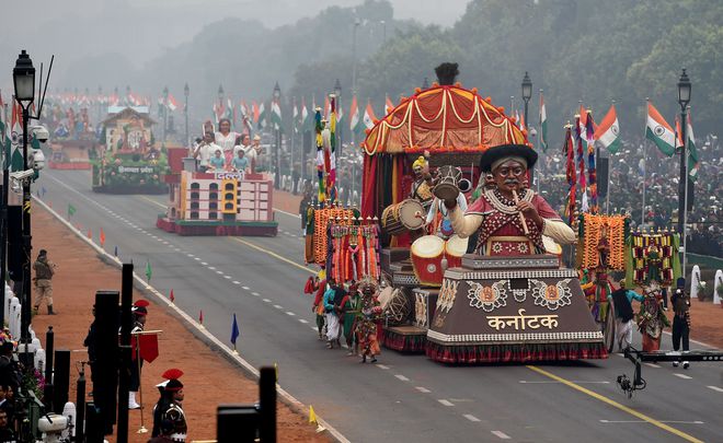 Performers surround a tableaux representing the state of Karnataka during 68th Republic Day parade in New Delhi on January 26