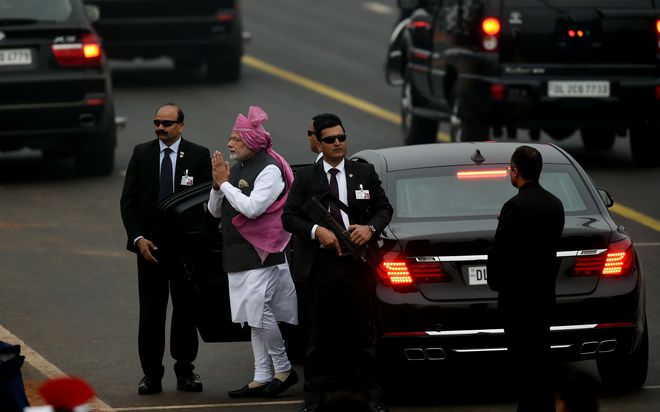 Prime Minister Narendra Modi gestures as he arrives ahead of the 68th Republic Day parade in New Delhi