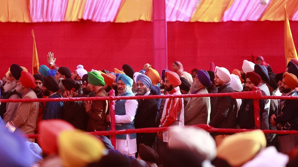Sikh devotees stand in a queue to pay obeisance at a Gurudwara in Jammu