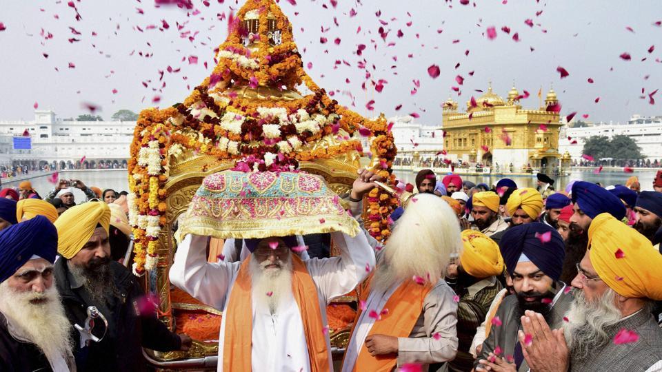 Sikh devotees take part in a procession at the Golden Temple on the eve of the 350th birth anniversary of Guru Gobind Singh in Amritsar