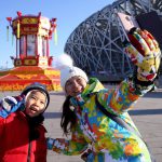 This photo taken on January 22 shows Chinese tourists taking selfies as they visit a palace lantern display at Beijing Olympic Park in Beijing