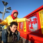 This photo taken on January 22 shows a Chinese man and his daughter visiting a window papercuts display at Beijing Olympic Park in Beijing