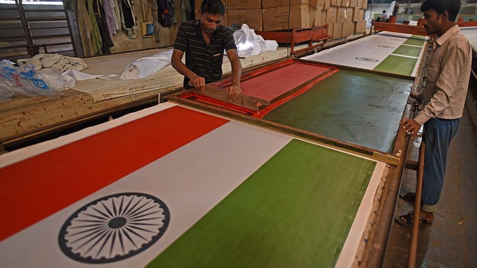 Workers paint the Tricolour in a workshop