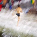 A boy runs out from the river Saali after taking a holy bath during the first day of Swasthani Brata Katha festival at Sankhu in Kathmandu