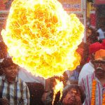A Hindu devotee demonstrates fire-breathing skills during a religious procession to mark the Hindu festival of Maha Shivratri in Allahabad