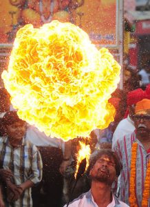 A Hindu devotee demonstrates fire-breathing skills during a religious procession to mark the Hindu festival of Maha Shivratri in Allahabad