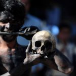 A Hindu devotee holds a human skull and bone during a procession for Maha Shivaratri, dedicated to the Hindu god Lord Shiva, in Allahabad on February 24
