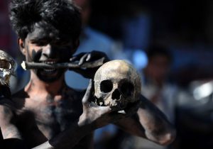 A Hindu devotee holds a human skull and bone during a procession for Maha Shivaratri, dedicated to the Hindu god Lord Shiva, in Allahabad on February 24