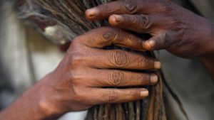 A Hindu holy man, or sadhu, arranges his hair at the premises of Pashupatinath Temple