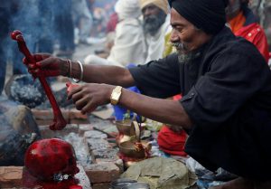A Hindu holy man, or sadhu, offers prayers on a human skull at the premises of Pashupatinath Temple during the Shivaratri festival in Kathmandu, Nepal February 24, 2017