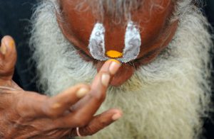 A Nepalese Hindu Sadhu (Holy man) smears colored paste onto his forehead near the Pashupatinath Temple during the Hindu festival Maha Shivaratri in KathmanduA Nepalese Hindu Sadhu (Holy man) smears colored paste onto his forehead near the Pashupatinath Temple during the Hindu festival Maha Shivaratri in Kathmandu