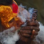 A Nepalese Sadhu (Hindu holy man) smokes a chillum, a traditional clay pipe, as a holy offering to Lord Shiva, the Hindu god of creation and destruction near the Pashupatinath Temple in Kathmandu on Febuary 23, 2017, on the eve of the Hindu festival Maha Shivaratri. Hindus mark the Maha Shivratri festival by offering prayers and fasting