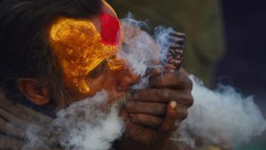 A Nepalese Sadhu (Hindu holy man) smokes a chillum, a traditional clay pipe, as a holy offering to Lord Shiva, the Hindu god of creation and destruction near the Pashupatinath Temple in Kathmandu on Febuary 23, 2017, on the eve of the Hindu festival Maha Shivaratri. Hindus mark the Maha Shivratri festival by offering prayers and fasting