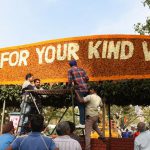 A board being installed at the exit gate of the garden